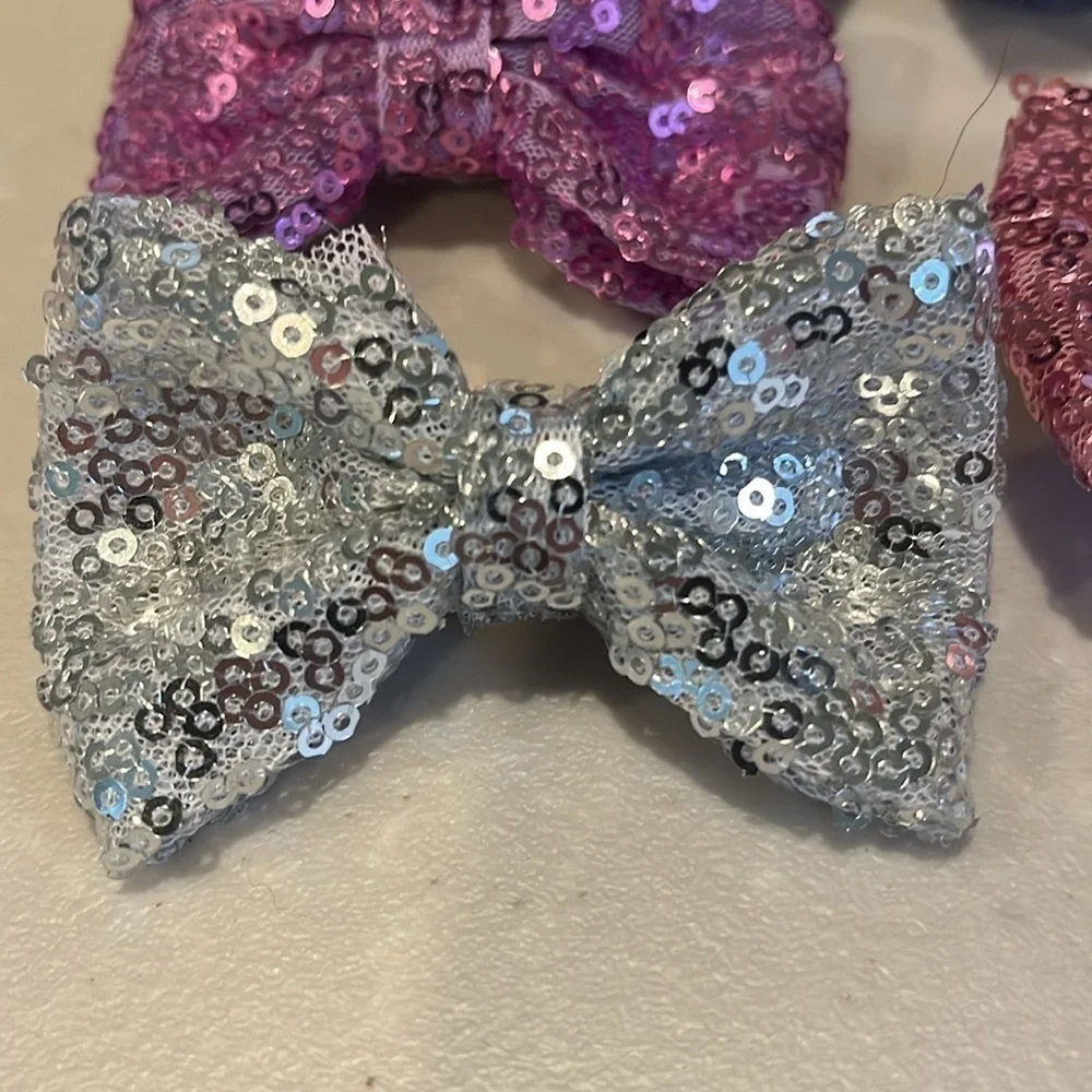 Set of 7.  Girls hair bows.  Alligator clips. 3 inches long.  Sparkly